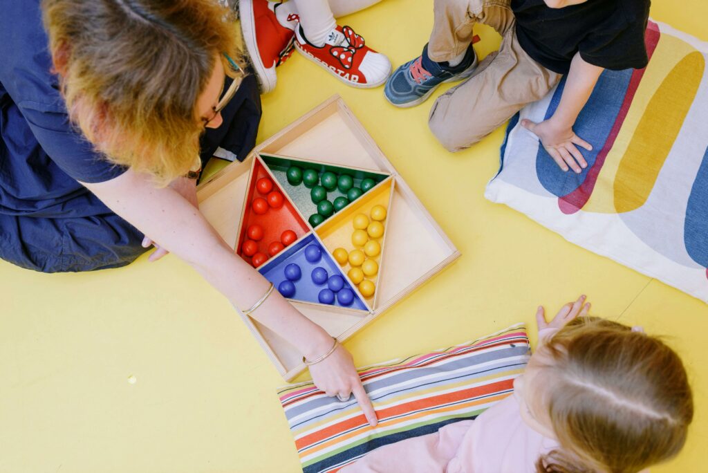 pexels-photo-8535568-8535568 Children gathered around a colorful educational game in a classroom setting, enhancing learning.